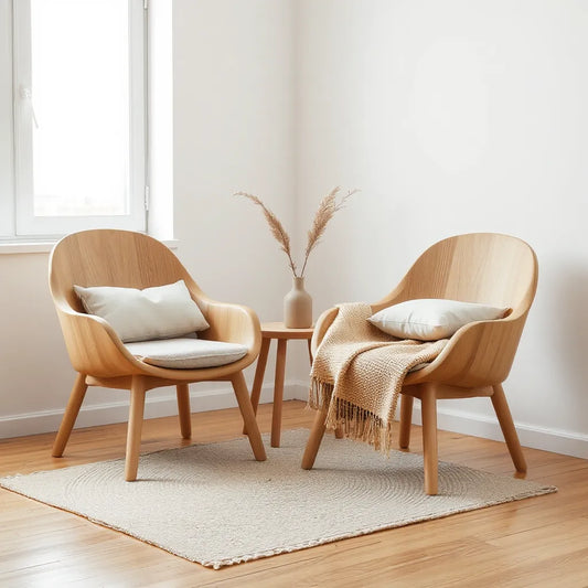 Two natural wood bucket chairs styled with neutral cushions in a cozy living room corner