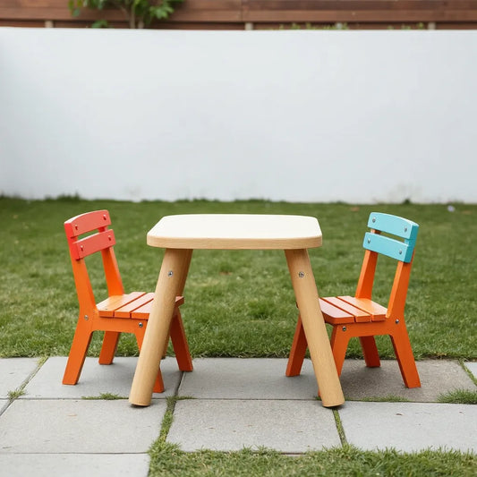 Kids picnic table with two matching chairs in an outdoor play area