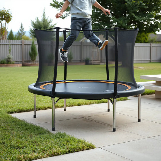 Child safely jumping on a kids electric trampoline outdoors with protective net and padded frame