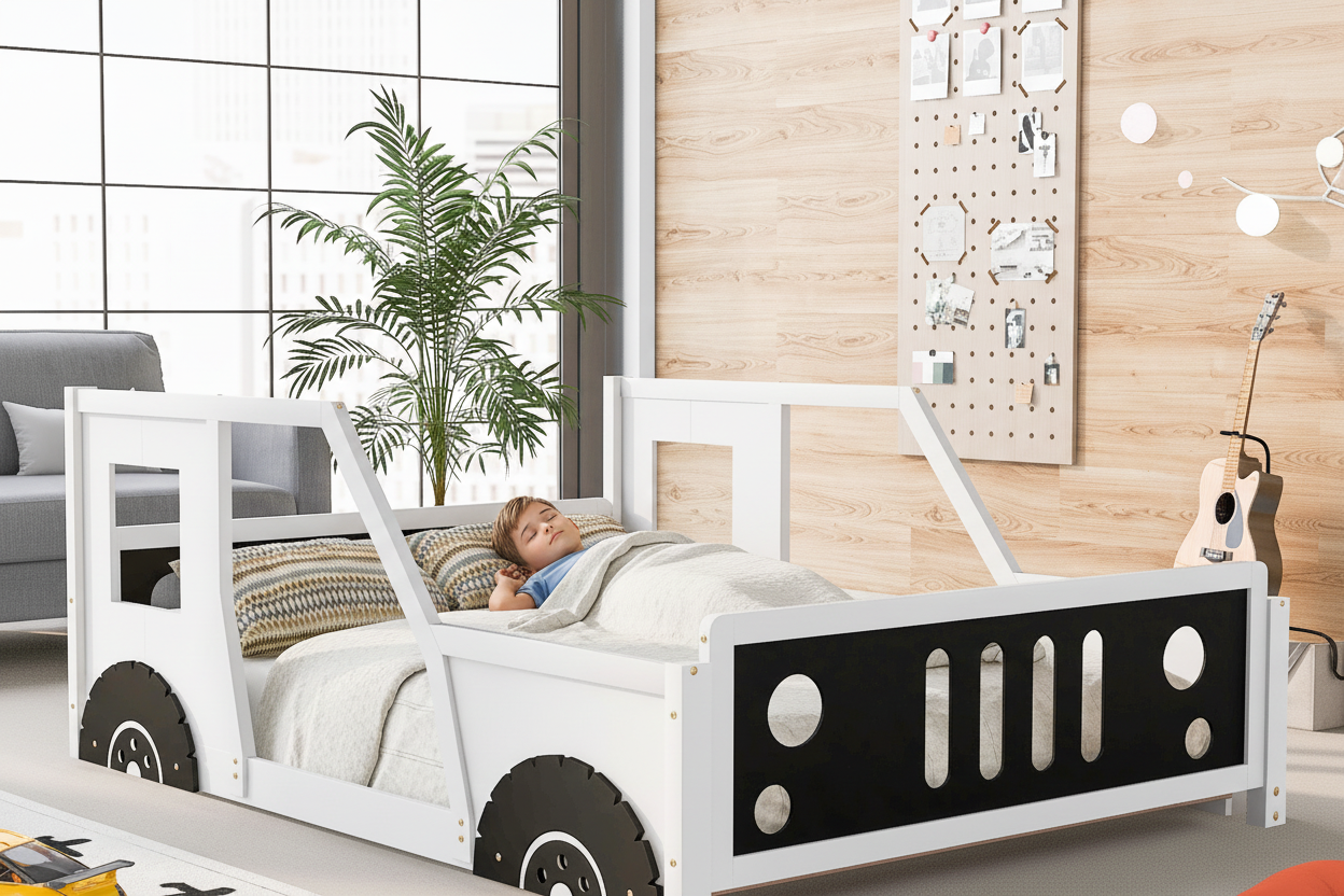 Child lying in a white truck-shaped bed with black details in a room with a plant and wall decorations.