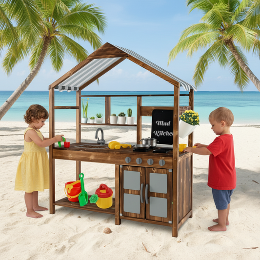 Children playing with a wooden play kitchen on a sandy beach with palm trees and ocean in the background.