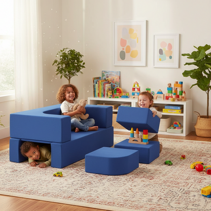 Children playing with blue soft play furniture in a room with toys and books.