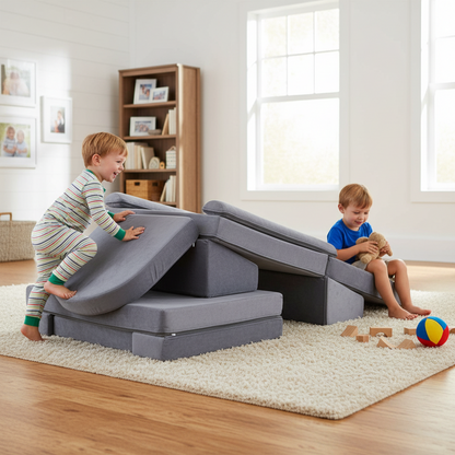 Children playing on a gray play couch in a bright living room.