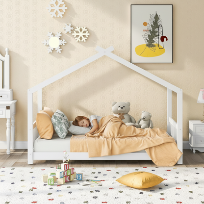 Child in a white house-shaped bed with teddy bears, surrounded by toys and decor in a cozy bedroom.