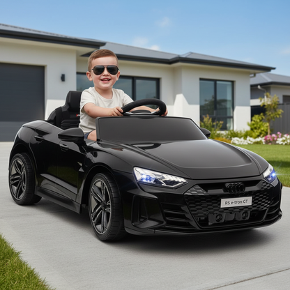 Child driving a black toy car in front of a house