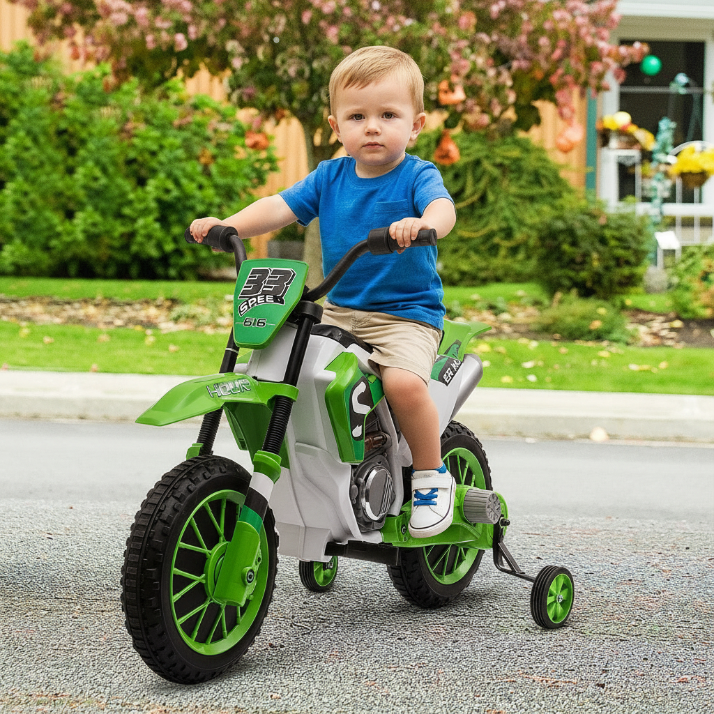 Child riding a green and white toy motorcycle in a driveway.